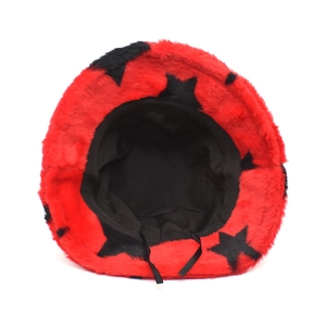 Detail of red plush bucket hat featuring black star patterns and adjustable inner lining