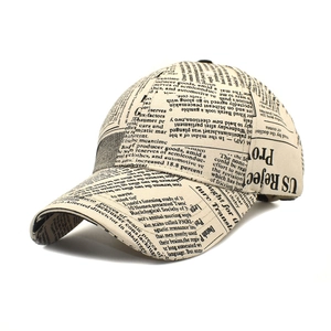 Macro detail of vintage newspaper print texture on a cream cotton baseball cap
