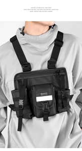 Close-up of tactical chest rig featuring reflective stripe and durable buckle details