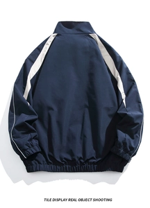 Detail view of men's navy blue stand collar jacket with white reflective patchwork back