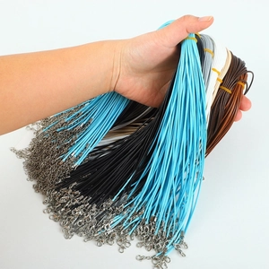 Detailed view of assorted colorful necklace cords with metal lobster clasps and chains