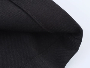 Close-up of black fabric texture with reinforced stitching for women's vest and pants set