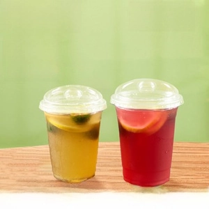 Close-up of clear high-dome PET lids on transparent disposable coffee and tea cups