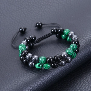 Double layer braided bracelet with malachite beads and black hematite on leather background