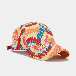 Detail of colorful tie-dye baseball cap featuring a vibrant curved brim and six-panel crown