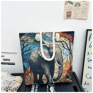 Close-up of artistic elephant canvas tote with colorful mosaic patterns and rope handle