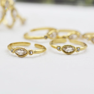 Adjustable stainless steel ring with marquise cut cubic zirconia and gold finish