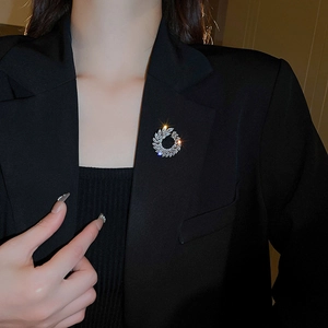 Macro shot of silver wreath brooch with zircons pinned on a black suit lapel