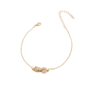 Detail of gold leopard head bracelet with white zircons and green gemstone eyes