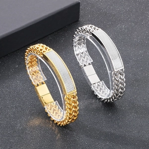 Detail of gold and silver hip hop bracelets with woven chains and magnetic clasps