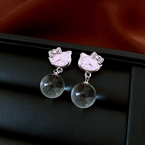 Detailed close-up of pink Hello Kitty earrings with silver metal and clear glass beads