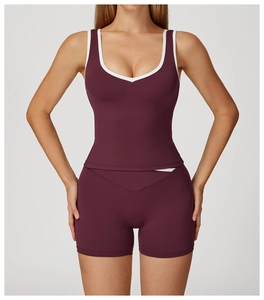 Detail of burgundy sports set with white contrast piping and high-waist yoga shorts