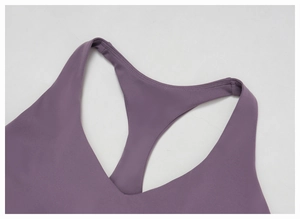 Detail of purple racerback yoga bra with reinforced double-row stitching and elastic fabric