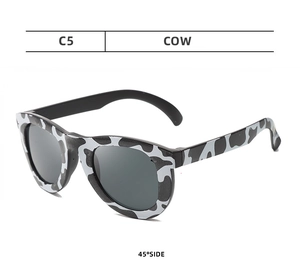 Detail view of round children's glasses with C5 cow print frame at 45-degree angle