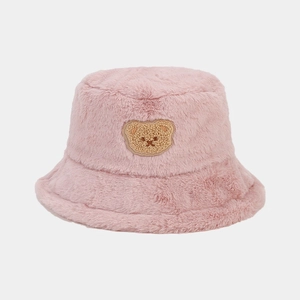 Close-up of pink faux fur bucket hat with cute brown teddy bear embroidery detail