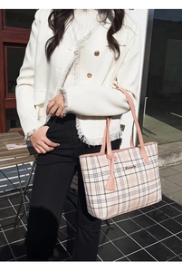 Pink checkered tote bag detail featuring premium pink handles and gold-tone hardware