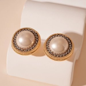 French vintage pearl stud earrings with gold and silver chain accents on display
