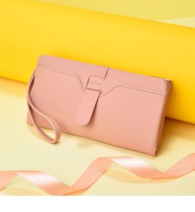 Pink PU leather long wallet detail shot, elegant wrist strap and flap closure design.