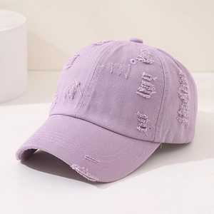 Detailed view of lavender distressed baseball cap featuring vintage frayed fabric textures