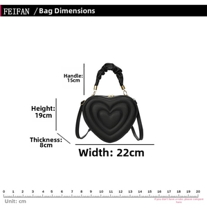 Detailed size guide for black heart-shaped handbag with quilted pattern and dimensions