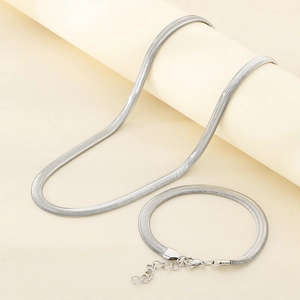 Close-up of a silver stainless steel flat snake chain necklace and bracelet set