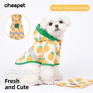 Detail of dog raincoat with fruit pattern, green trim, and safety reflective strips