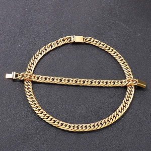 Detailed view of golden Cuban link necklace and bracelet set with box clasps