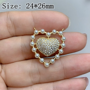 Detail view of a 24x26mm heart pendant with pearls and micro-pave crystals