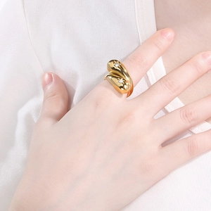 Detail of water drop knot ring with 18K gold plating and sparkling gemstones on finger