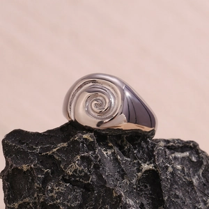 Close-up of a 18K gold plated stainless steel ring with a 3D spiral vortex design