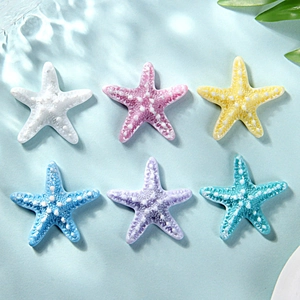 Macro detail of colorful resin starfish accessories for DIY crafts and hair clips