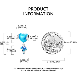 Blue enamel heart charm with leaf detail and size measurements next to a coin for scale