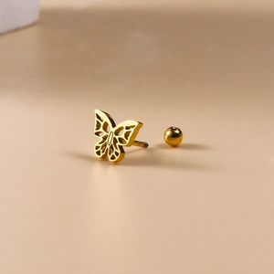 Detailed view of a golden butterfly cartilage piercing stud with a round ball screw back