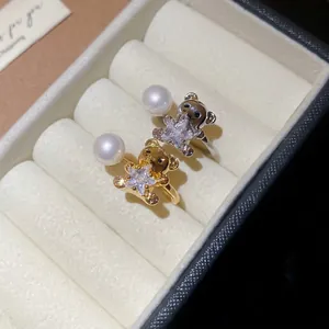 Adjustable bear and star open ring with pearl in gold and silver finish, 45-degree view