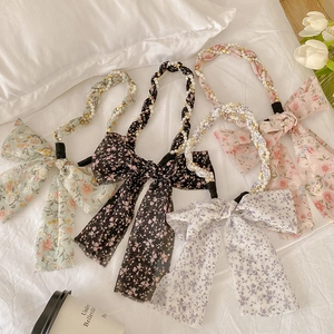 Floral hair ribbons with pearls and bows in green, black, pink, and white colors