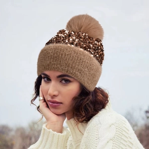 Winter knit beanie with sequins and large faux fur pompom in caramel brown color
