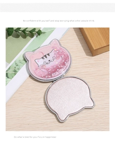 Detail of a cat-shaped quicksand makeup mirror showing pink glitter and floating sequins