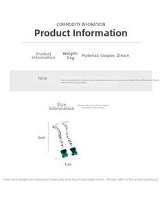 Detail view of long copper drop earrings with white zircons and emerald green stone