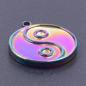 Close-up of a rainbow 304 stainless steel Yin Yang Tai Chi pendant with metallic luster