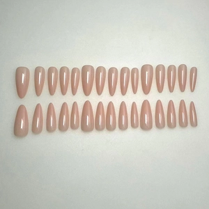 Set of 24 glossy nude pink press-on nails in long almond shape on a neutral background