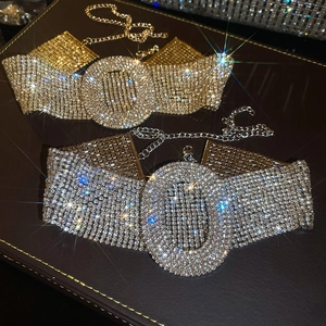 Close-up of gold and silver luxury rhinestone chokers with oval crystal centerpieces