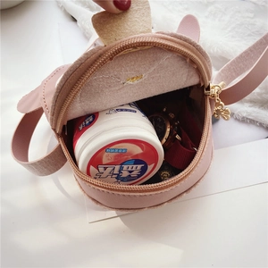 Pink penguin-style mini bag interior showing capacity for watch and small items