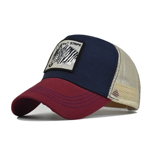 Detail of zebra embroidery patch on a vintage navy and burgundy mesh trucker hat