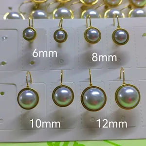 Detail view of pearl earrings in four sizes with golden stainless steel leverback hooks