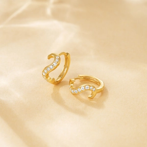 Detailed macro view of S925 hallmark on gold plated sterling silver hoop earrings with diamonds