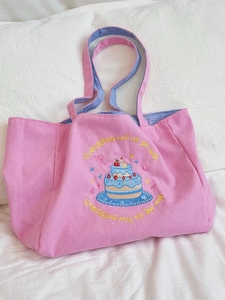 Pink canvas tote bag with cake embroidery and blue checkered inner lining handles