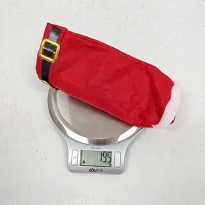 Detailed weight measurement of a Santa pants candy bag on a digital kitchen scale