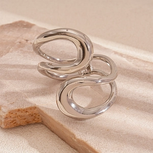 Detail of silver twisted geometric ring with a polished finish on natural stone
