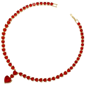 Macro detail of red heart-shaped gemstone necklace with gold-tone setting