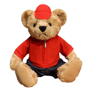 Plush teddy bear toy in red jacket and baseball cap with denim shorts on white background